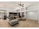 Open-concept living room with tan sectional, travertine floors, and kitchen with stone-wrapped island at 18036 N 49Th St, Scottsdale, AZ 85254