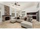 Light-filled living room featuring vaulted ceiling, stone fireplace, and views of the kitchen and dining area at 18036 N 49Th St, Scottsdale, AZ 85254