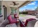 Inviting covered patio features ample seating, a ceiling fan, and clear views of the landscaped backyard at 1961 E Stacey Rd, Gilbert, AZ 85298