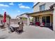 Outdoor patio featuring a dining table, grill, and covered seating, perfect for enjoying meals and relaxing outdoors at 1961 E Stacey Rd, Gilbert, AZ 85298