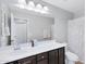 Bright bathroom featuring a sink vanity with a large mirror, a shower/tub combo, and neutral color tones at 1961 E Stacey Rd, Gilbert, AZ 85298