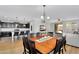 Open-concept dining area with a large wooden table, kitchen island, and access to outdoor patio at 1961 E Stacey Rd, Gilbert, AZ 85298