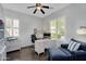 Bright home office with a modern desk, comfortable seating, and plantation shutters at 1961 E Stacey Rd, Gilbert, AZ 85298