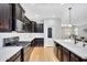 Modern kitchen with stainless steel appliances, dark cabinets, white countertops and hardwood floors at 1961 E Stacey Rd, Gilbert, AZ 85298