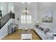 Bright living room with hardwood floors, lots of natural light, and a decorative chandelier at 1961 E Stacey Rd, Gilbert, AZ 85298