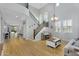 Bright living room with a staircase, hardwood floors, large windows, and a grand chandelier at 1961 E Stacey Rd, Gilbert, AZ 85298