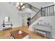 Open living area with hardwood floors, staircase, chandelier, and access to other rooms at 1961 E Stacey Rd, Gilbert, AZ 85298