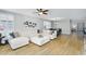 Open-concept living room with a white sectional sofa and an adjacent dining area at 1961 E Stacey Rd, Gilbert, AZ 85298