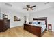 Main bedroom showcasing a large bed, hardwood floors, and neutral wall paint at 1961 E Stacey Rd, Gilbert, AZ 85298