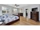 Main bedroom with a large bed, hardwood floors, and natural light from the windows at 1961 E Stacey Rd, Gilbert, AZ 85298
