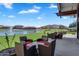 Inviting covered patio with seating area overlooking the community lake and lush green space at 1961 E Stacey Rd, Gilbert, AZ 85298