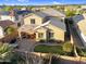 Aerial view of a two-story home with a cozy covered patio, paver patio, and well-maintained backyard at 1961 E Stacey Rd, Gilbert, AZ 85298