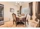 Cozy dining area featuring a stylish chandelier, custom window coverings, and a wine cooler at 2059 W Whisper Rock Trl, Phoenix, AZ 85085