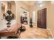 Warm entryway featuring tile flooring, a console table, and a view into the office at 2059 W Whisper Rock Trl, Phoenix, AZ 85085