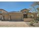 Charming home showcasing a three-car garage, stone accents and desert landscaping at 2059 W Whisper Rock Trl, Phoenix, AZ 85085