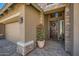 Inviting entryway features a wooden front door with a wreath and a potted plant at 2059 W Whisper Rock Trl, Phoenix, AZ 85085