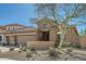 Beautiful home exterior featuring a three-car garage, stone accents and desert landscaping at 2059 W Whisper Rock Trl, Phoenix, AZ 85085