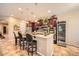Elegant kitchen with granite countertops, a breakfast bar, and updated stainless steel appliances and wine cooler at 2059 W Whisper Rock Trl, Phoenix, AZ 85085