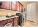 Functional laundry room with dark cabinets, counter space and modern washer and dryer at 2059 W Whisper Rock Trl, Phoenix, AZ 85085