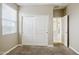 Bedroom featuring neutral walls, carpet floors, and a closet with sliding doors for storage at 22302 E Camina Plata --, Queen Creek, AZ 85142