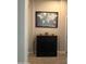 Hallway with a dark cabinet and interesting framed world map wall decor at 23497 S 212Th St, Queen Creek, AZ 85142