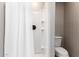 Bright bathroom featuring a shower with a white shower curtain and a modern toilet at 2644 E Sylvia St, Phoenix, AZ 85032
