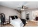 Serene bedroom featuring a queen bed, ceiling fan, and a decorative tree decal at 2644 E Sylvia St, Phoenix, AZ 85032