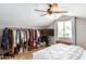 Attic bedroom includes TV, built-in closet, and a window for natural light at 2644 E Sylvia St, Phoenix, AZ 85032