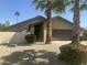 Charming single-story home featuring desert landscaping, mature palm trees and an attached two car garage at 2644 E Sylvia St, Phoenix, AZ 85032