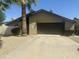 View of single-story house featuring desert landscaping, a spacious driveway, and a two car garage at 2644 E Sylvia St, Phoenix, AZ 85032