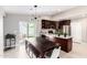 Open kitchen and dining area with a modern light fixture and access to the backyard at 2644 E Sylvia St, Phoenix, AZ 85032
