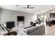 Open-concept living area with modern furnishings and a seamless flow to the dining area and kitchen at 2644 E Sylvia St, Phoenix, AZ 85032