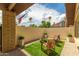 Cozy patio with artificial turf, gravel, seating, and a fire pit at 2644 E Sylvia St, Phoenix, AZ 85032