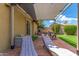 Relaxing covered patio featuring lounge chairs, ideal for enjoying the serene backyard and pool area at 2644 E Sylvia St, Phoenix, AZ 85032