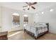 Bright bedroom with tiled floors, arched windows, ceiling fan, and neutral decor at 2656 E Longhorn Pl, Chandler, AZ 85286