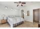 Comfortable bedroom featuring tile flooring, ceiling fan, and neutral paint, creating a relaxing space at 2656 E Longhorn Pl, Chandler, AZ 85286