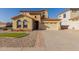 Two-story home featuring a clay tile roof, a two-car garage and well maintained desert landscaping at 2656 E Longhorn Pl, Chandler, AZ 85286