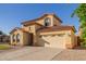 Two-story corner-lot home with low maintenance desert landscaping, a two-car garage and clay tile roof at 2656 E Longhorn Pl, Chandler, AZ 85286