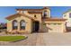 Two-story home featuring a clay tile roof, a two-car garage and well maintained desert landscaping at 2656 E Longhorn Pl, Chandler, AZ 85286