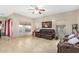 Spacious living room features tile flooring, a ceiling fan, multiple windows and comfortable furniture at 2656 E Longhorn Pl, Chandler, AZ 85286