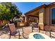 Inviting backyard with a built-in grill, cozy seating around a fire pit, and mature landscaping at 26735 N 127Th Dr, Peoria, AZ 85383