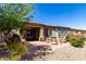 Expansive backyard with an outdoor kitchen, covered patio, fire pit, and beautiful desert landscaping at 26735 N 127Th Dr, Peoria, AZ 85383