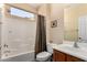 Cozy bathroom featuring a shower-tub combination, wooden vanity, and soft neutral color palette at 26735 N 127Th Dr, Peoria, AZ 85383
