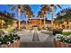 Night-lit courtyard with palm trees and outdoor dining area at 26735 N 127Th Dr, Peoria, AZ 85383
