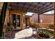 Welcoming covered patio area with cozy seating, ambient lighting, and a view of the manicured garden at 26735 N 127Th Dr, Peoria, AZ 85383