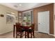 Cozy dining area with a wood table and sliding glass door access to backyard at 26735 N 127Th Dr, Peoria, AZ 85383