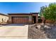 Charming single-story home featuring a two-car garage and a well-maintained desert landscape at 26735 N 127Th Dr, Peoria, AZ 85383