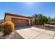 Two car garage with desert landscaping and large driveway at 26735 N 127Th Dr, Peoria, AZ 85383