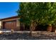 Two car garage, two tone exterior, desert landscaping and tree at 26735 N 127Th Dr, Peoria, AZ 85383