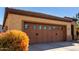 Two car garage with decorative door, glass panes and a large driveway at 26735 N 127Th Dr, Peoria, AZ 85383